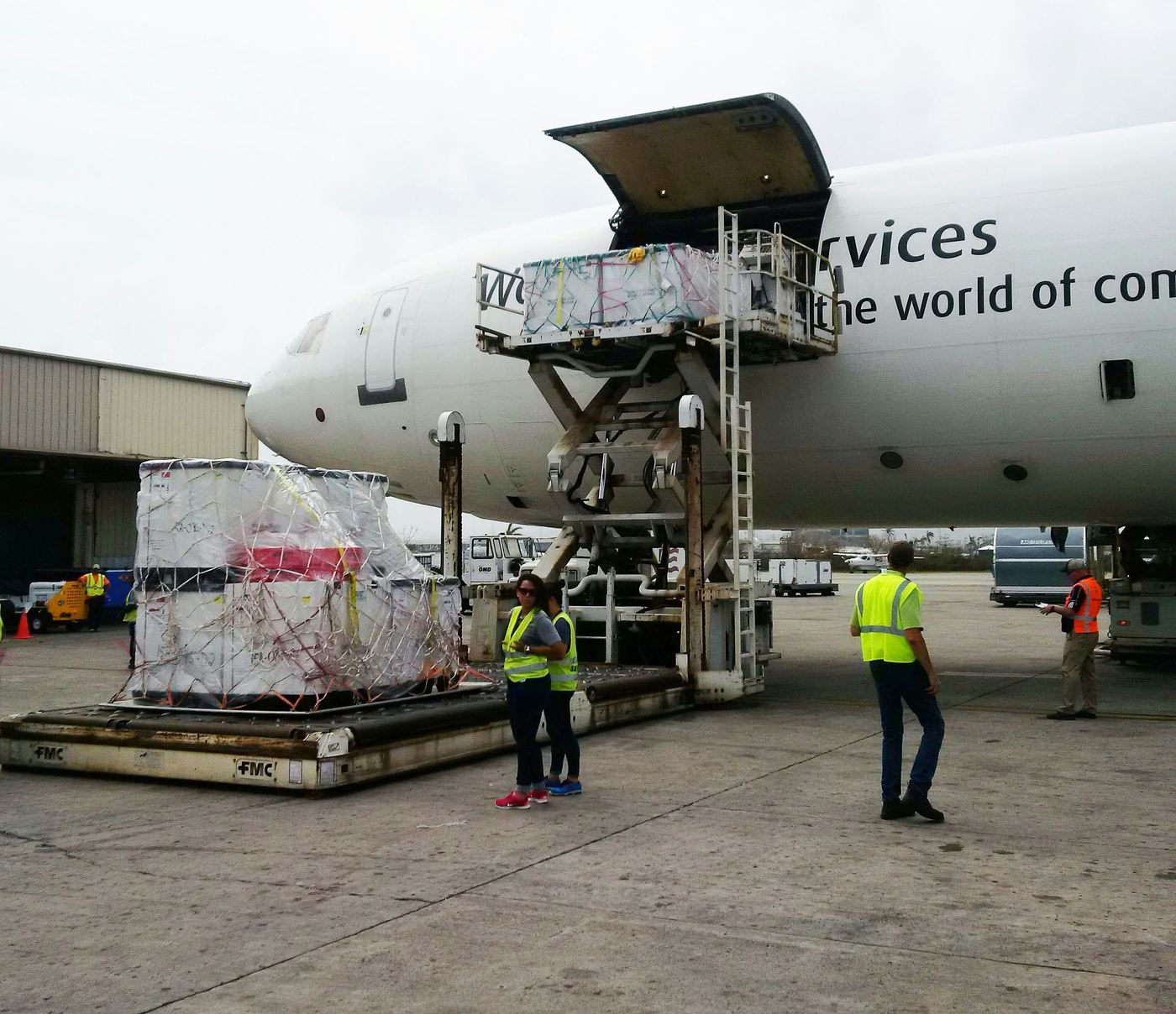 Cargo being loaded onto a freighter from a high loader