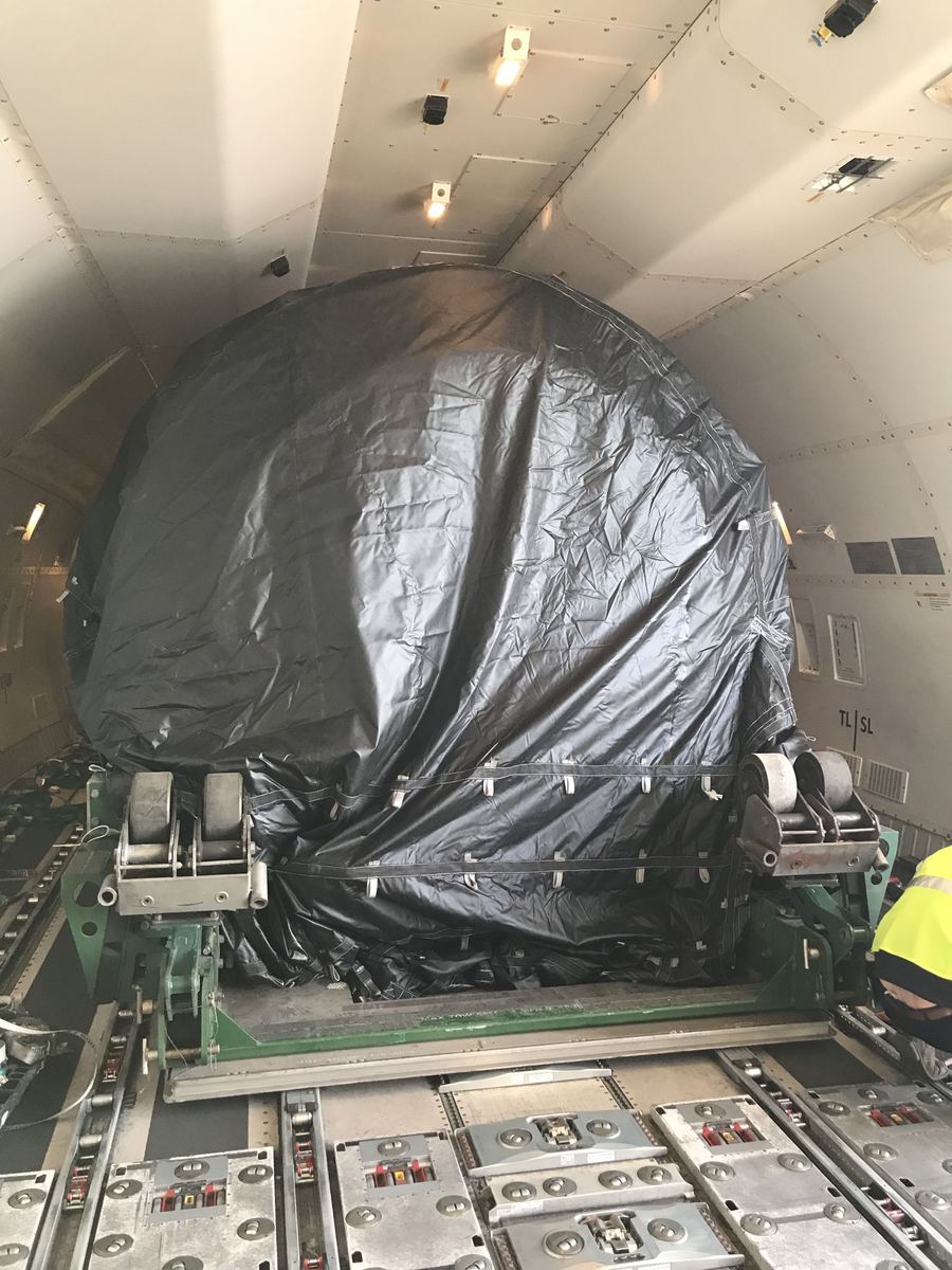 Oversize wrapped cargo positioned on a freighter main deck